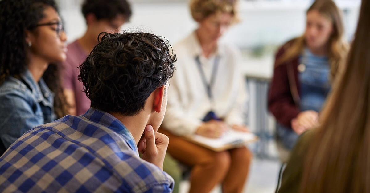 Young people participating in a therapist-led group counseling session.