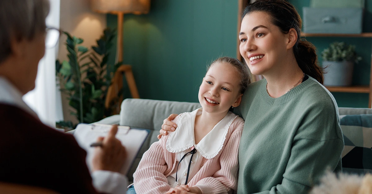 other and daughter speaking with a mental health professional during a family therapy session.